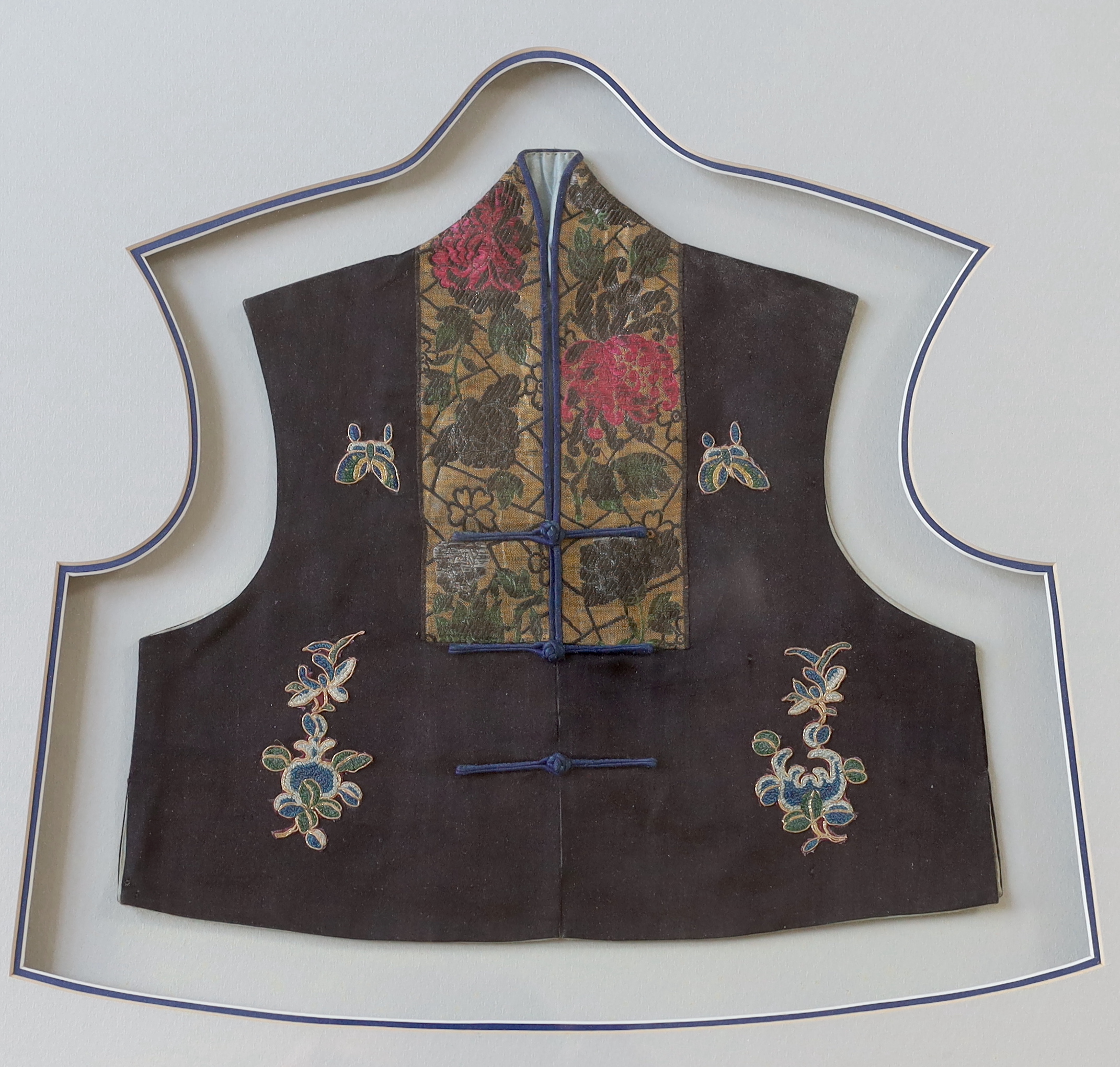 A late 19th century Chinese silk, multi-coloured metallic embroidered child's tabard front, together with a smaller, later silk and damask embroidered child’s waistcoat, larger panel: 34cm wide, 36cm high